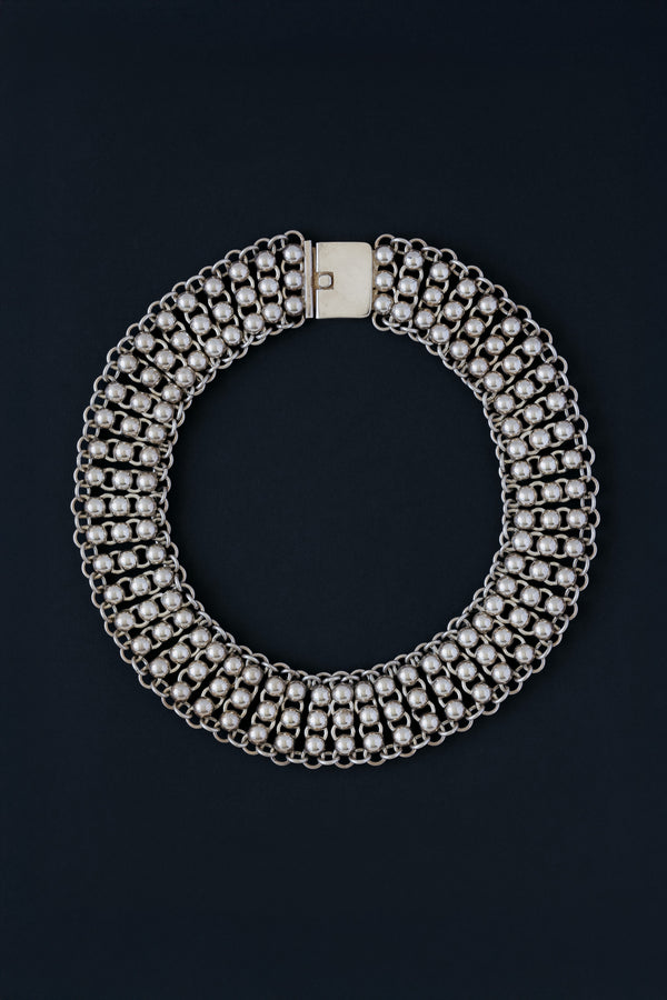 Vintage Mexican sterling silver ball and link collar necklace, front view on dark background