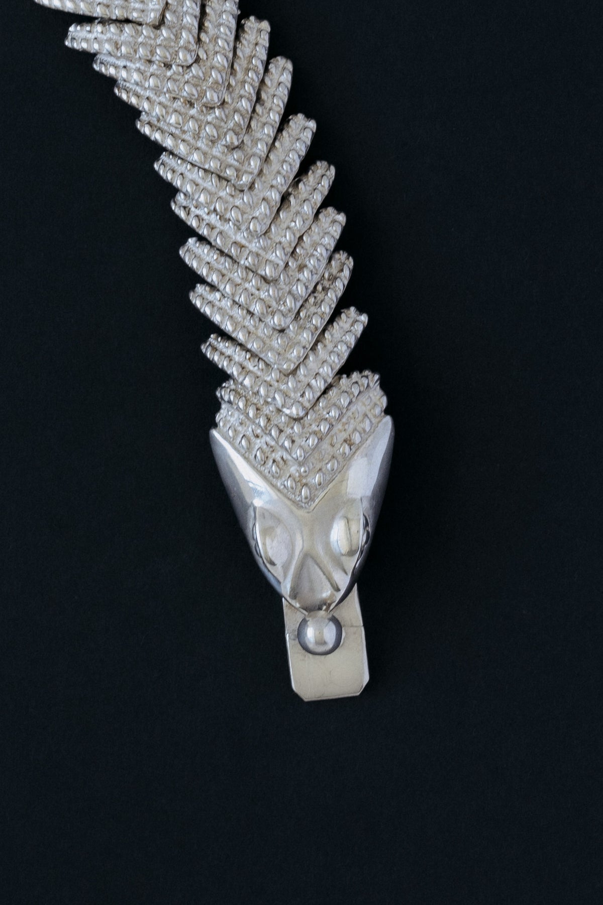 Close up of D'Molina sterling silver crocodile bracelet, chevron-woven scales, front view