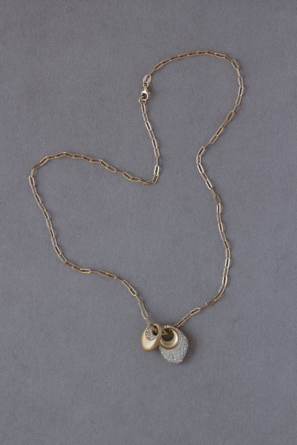 Pair of 18k Gold Egg Shaped Drop Pendants set with white diamonds on a grey background