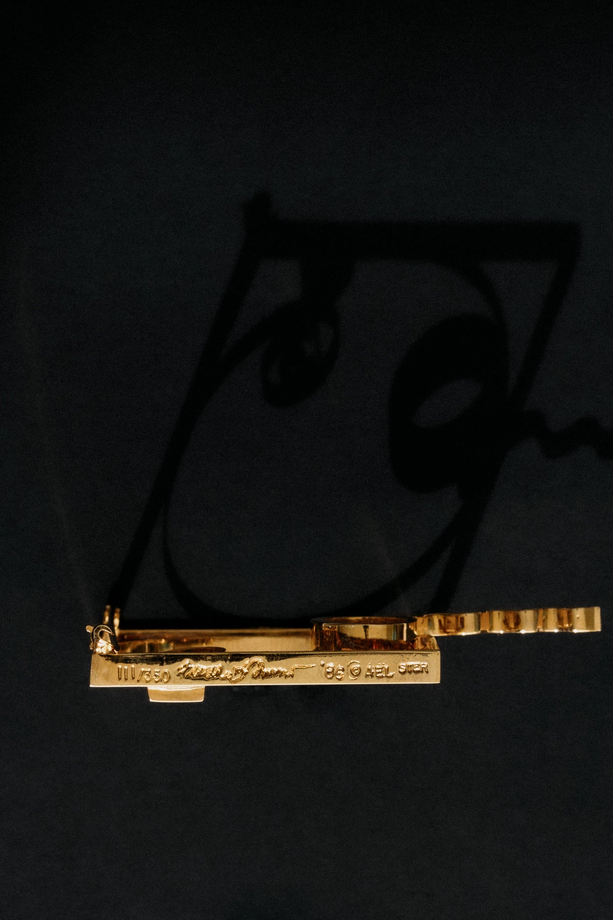 Close-up of Fletcher Benton signature, date 1986 and STER AEL hallmark on gold vermeil brooch