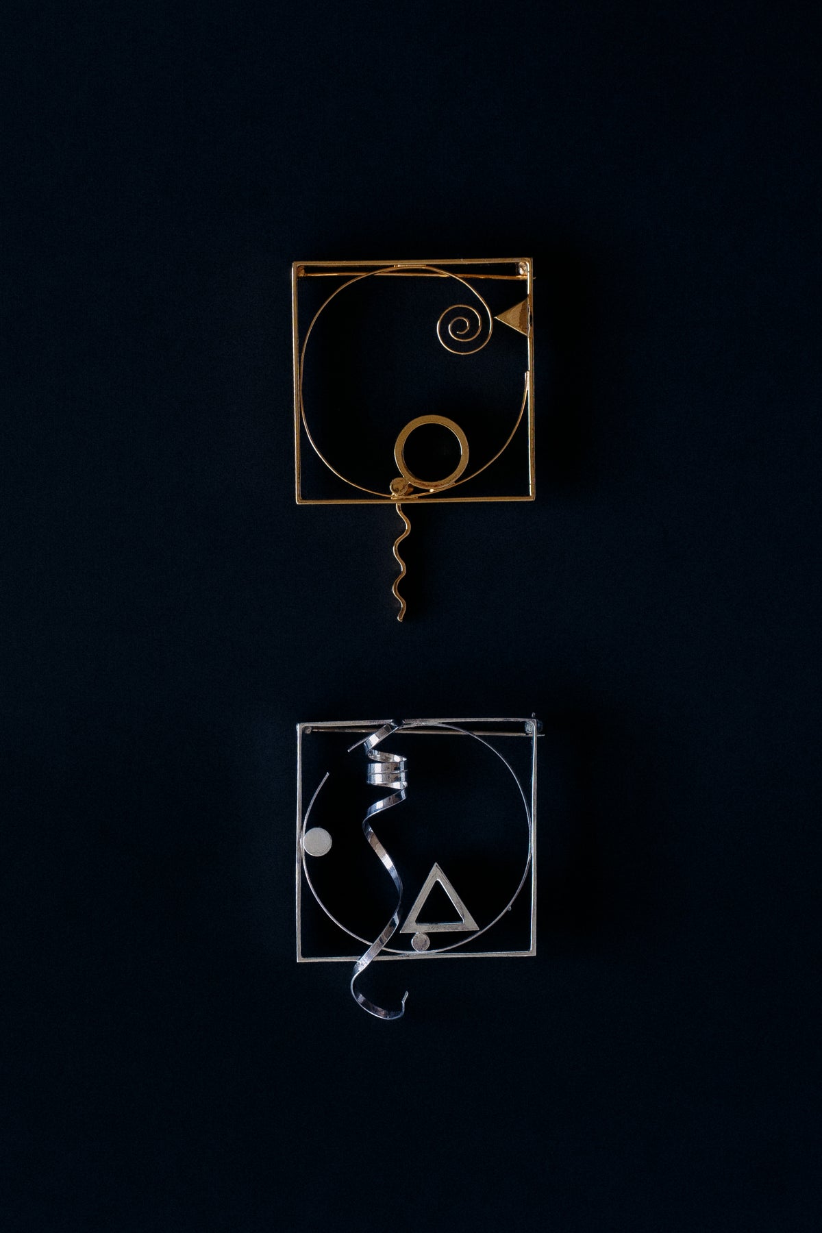 letcher Benton sterling silver and gold vermeil square frame brooches with twisted ribbon, 1986, front view