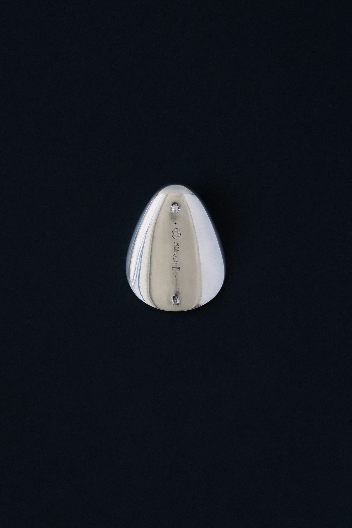 Close-up of Georg Jensen hallmark, 925 S, Denmark, 328, NJ stamped on sterling silver brooch