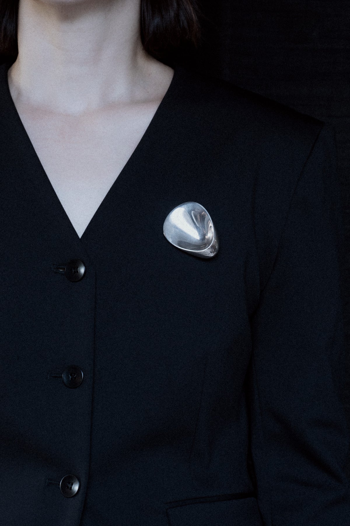 Georg Jensen Oyster brooch by Nanna Ditzel worn on blazer, sterling silver design 328