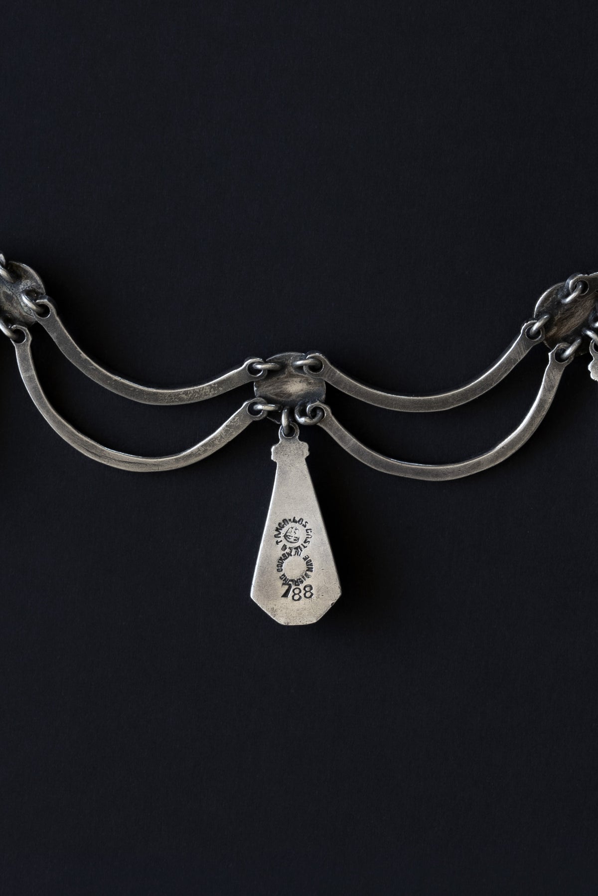 Close-up of Los Castillo Taxco hallmark, design number 788, and Mexican eagle assay stamp on sterling silver