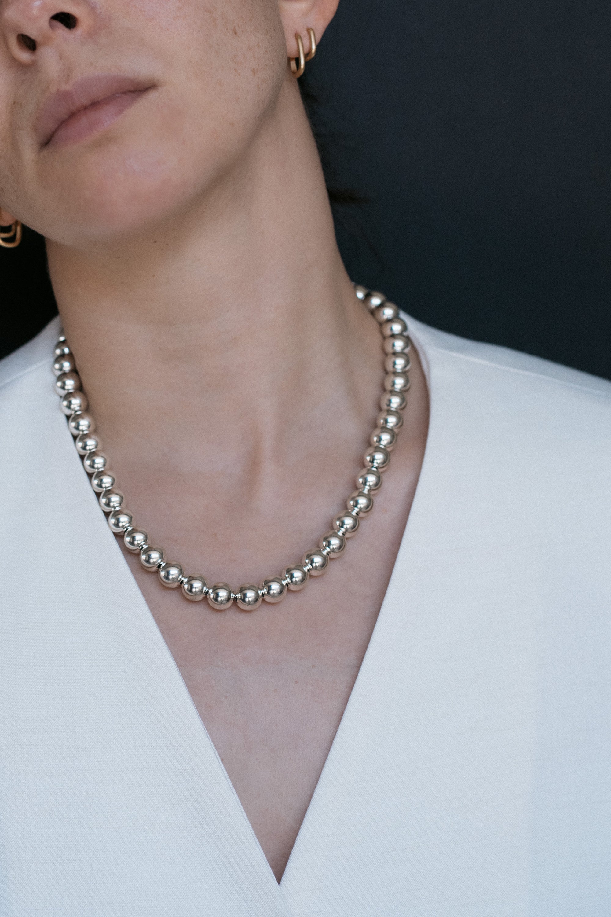 Silver beaded necklace on model