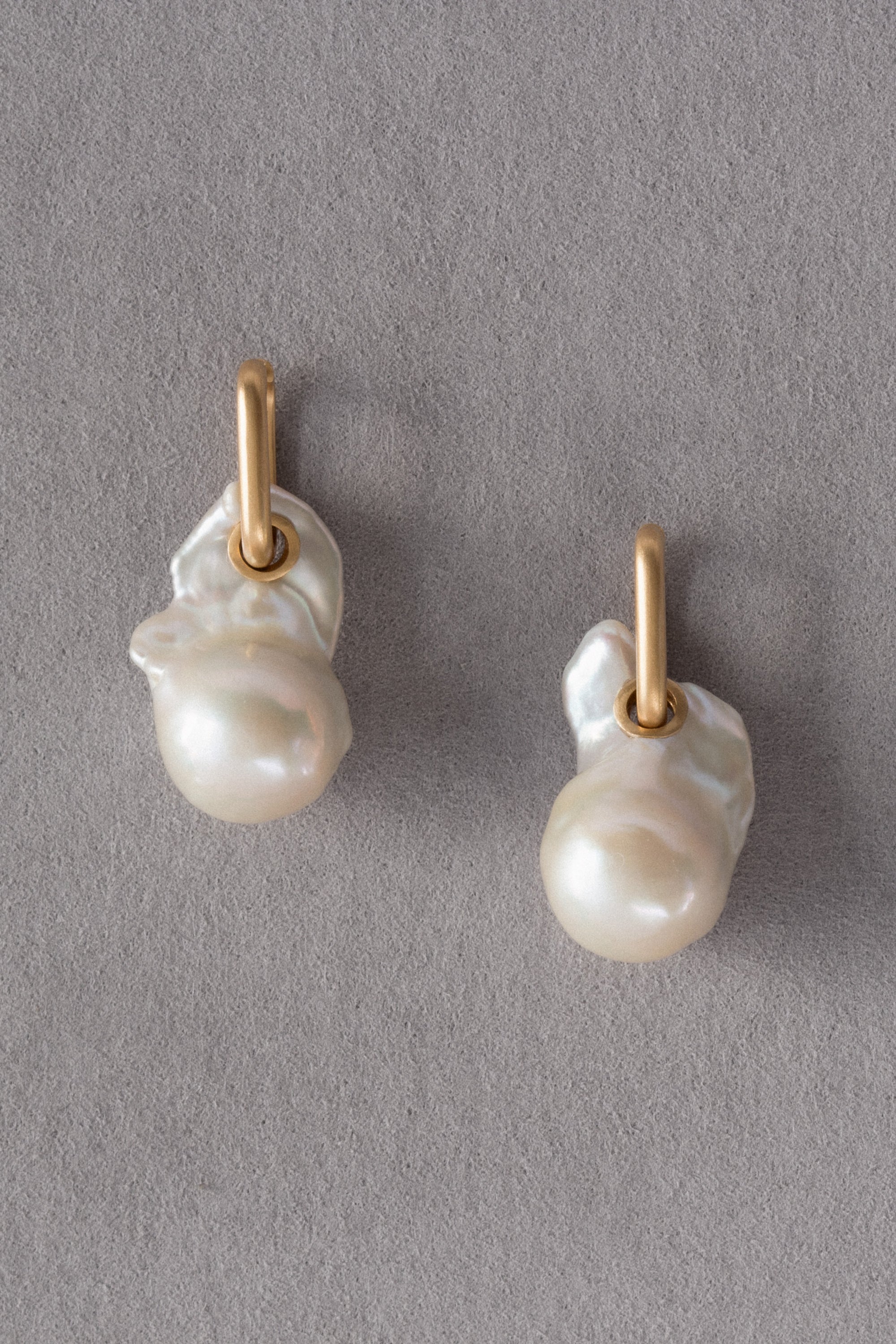 Ouvelle Mother of Pearl Fireball Earrings Gold on Grey Background