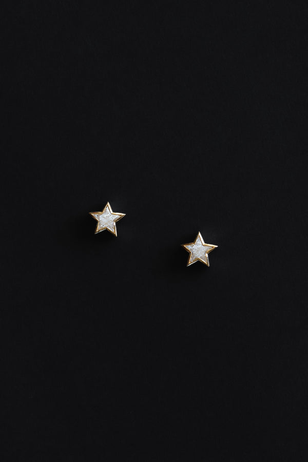 Ouvelle Custom cut star shaped white diamond small stud earrings set in 18 karat yellow gold on black backgroun