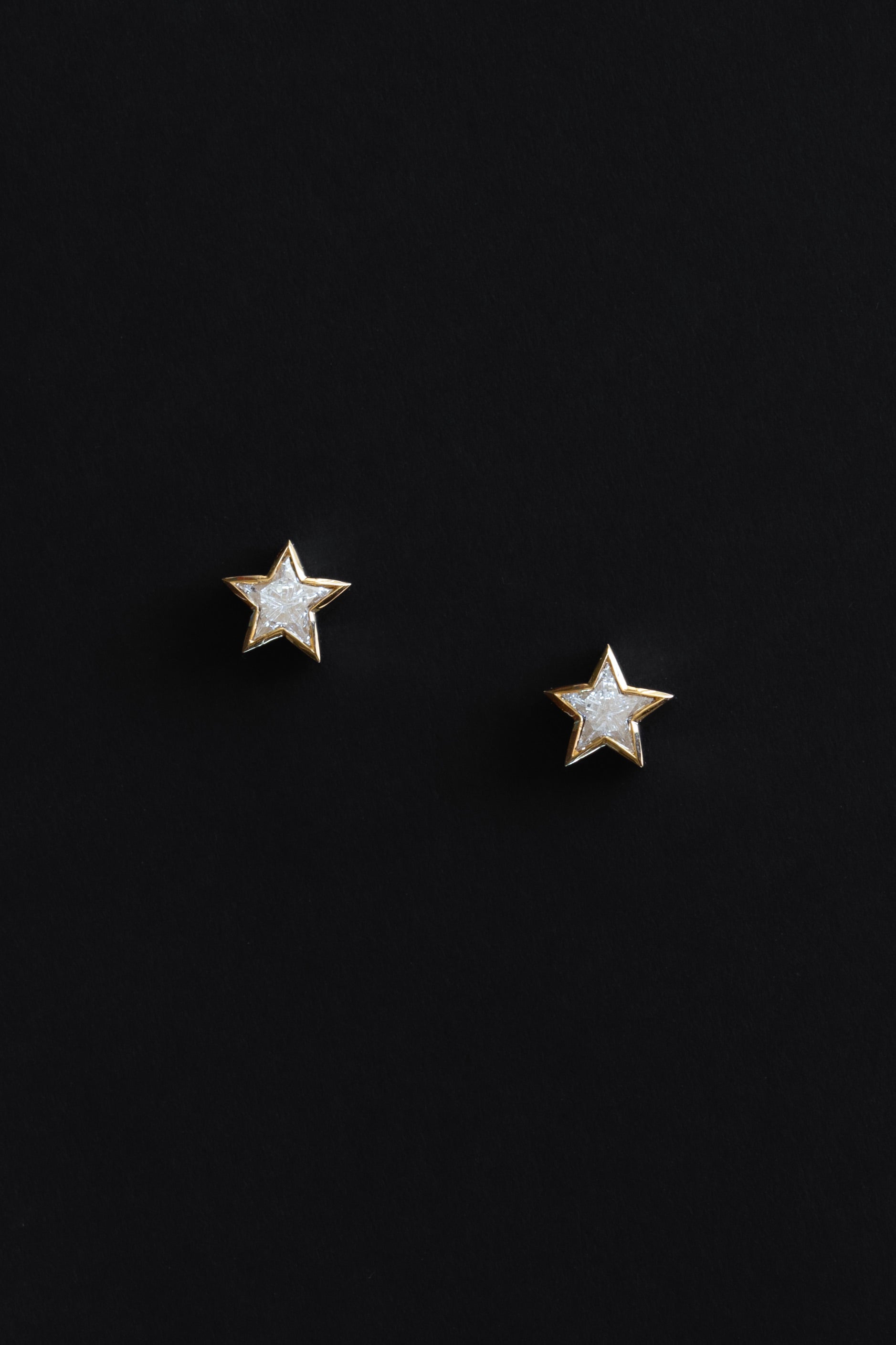 Ouvelle Custom cut star shaped white diamond medium stud earrings set in 18 karat yellow gold on black backgroun