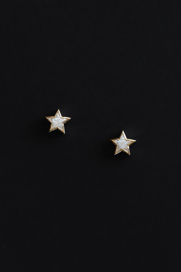 Ouvelle Custom cut star shaped white diamond medium stud earrings set in 18 karat yellow gold on black backgroun