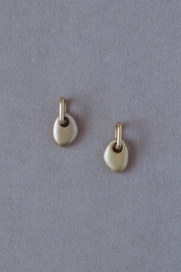 Pair of 18k Gold Egg Shaped Drop Earrings  set with white diamonds on a grey background back view
