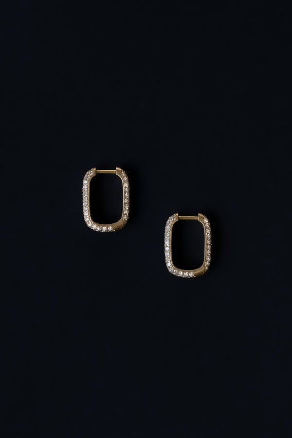 Ouvelle pair of gold and diamond pave rectangular rounded hoops on black background