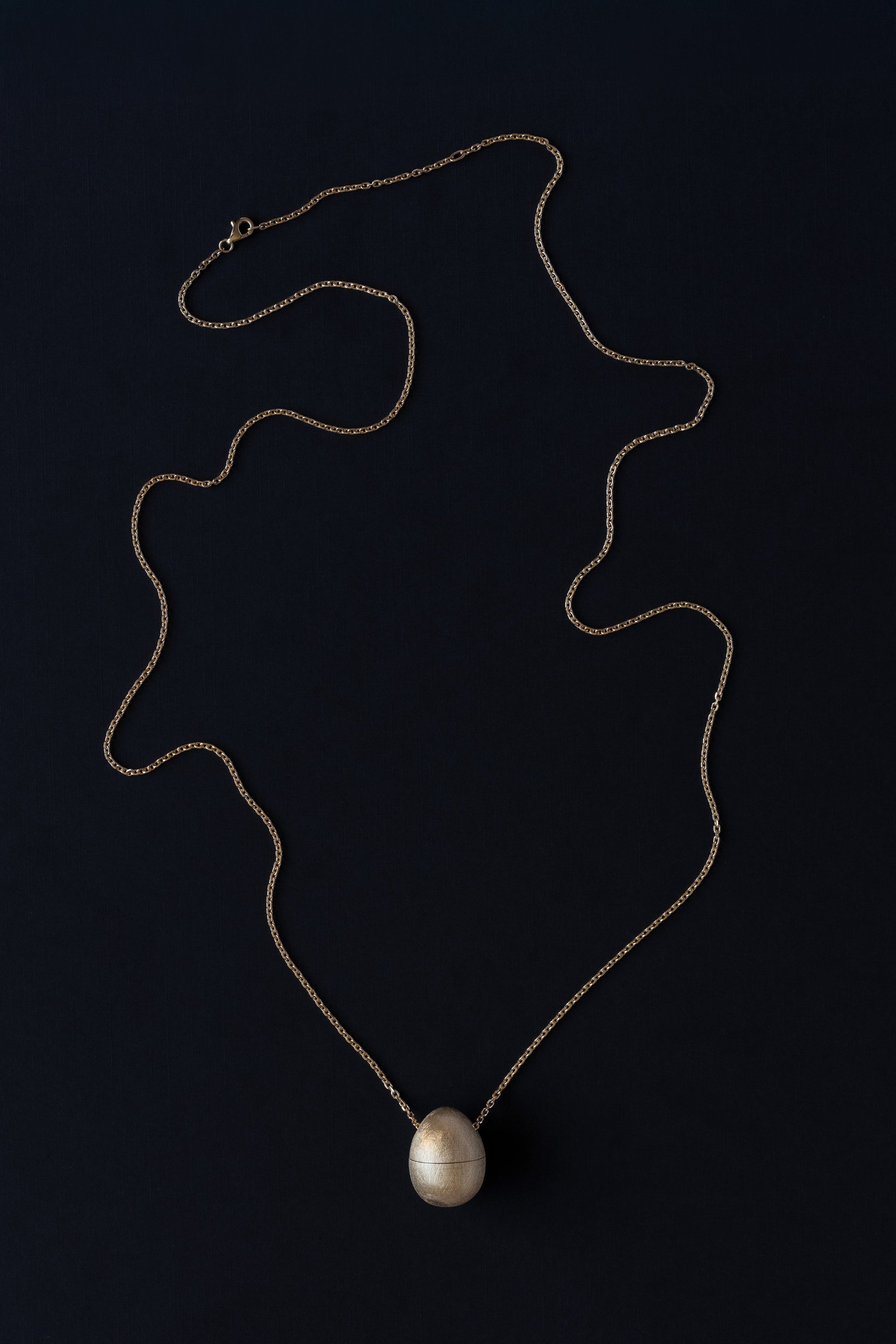 Egg shaped locket vessel necklace in 18k yellow gold 