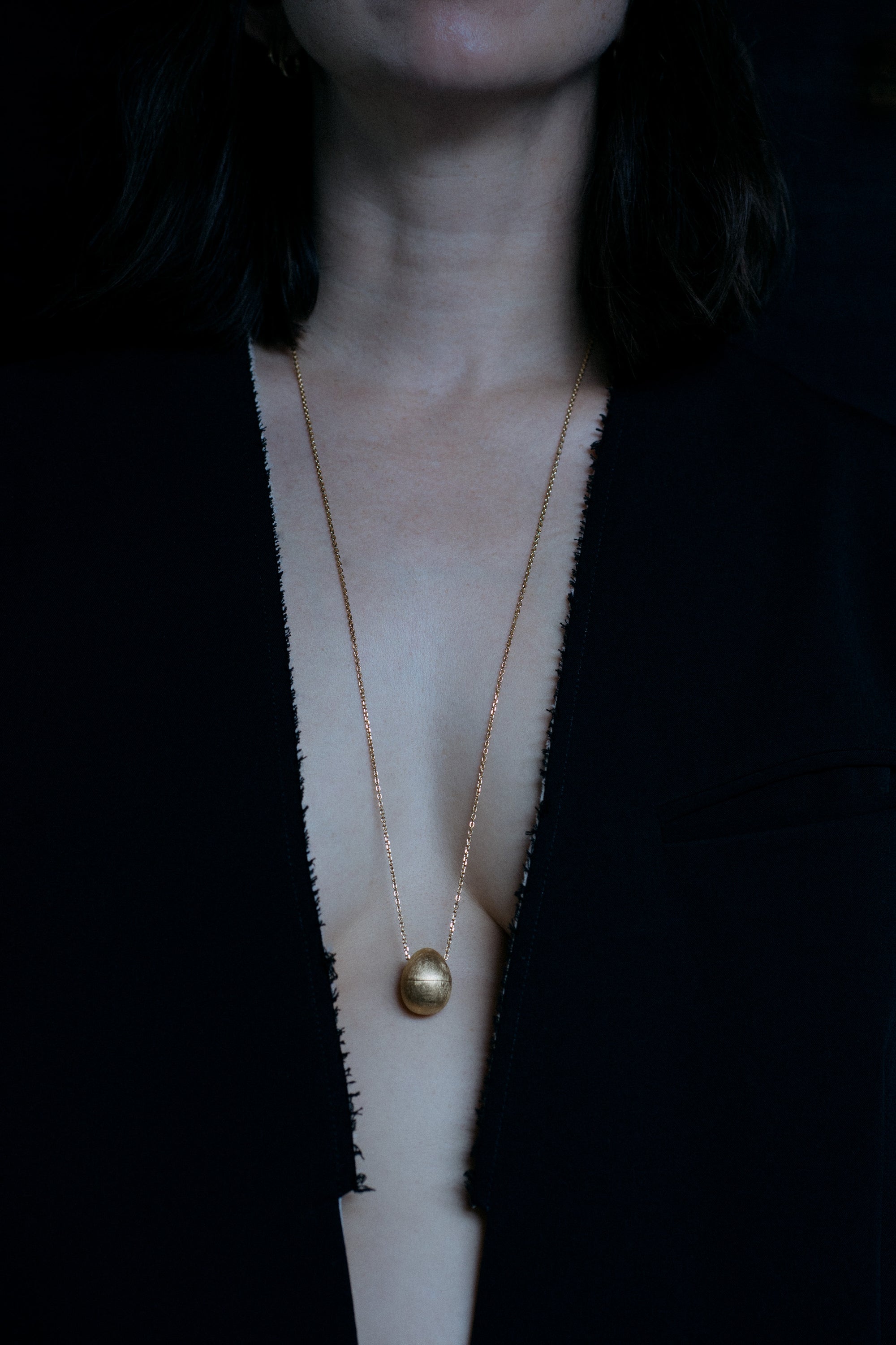 OUvelle Egg shaped locket vessel necklace in 18k yellow gold on model