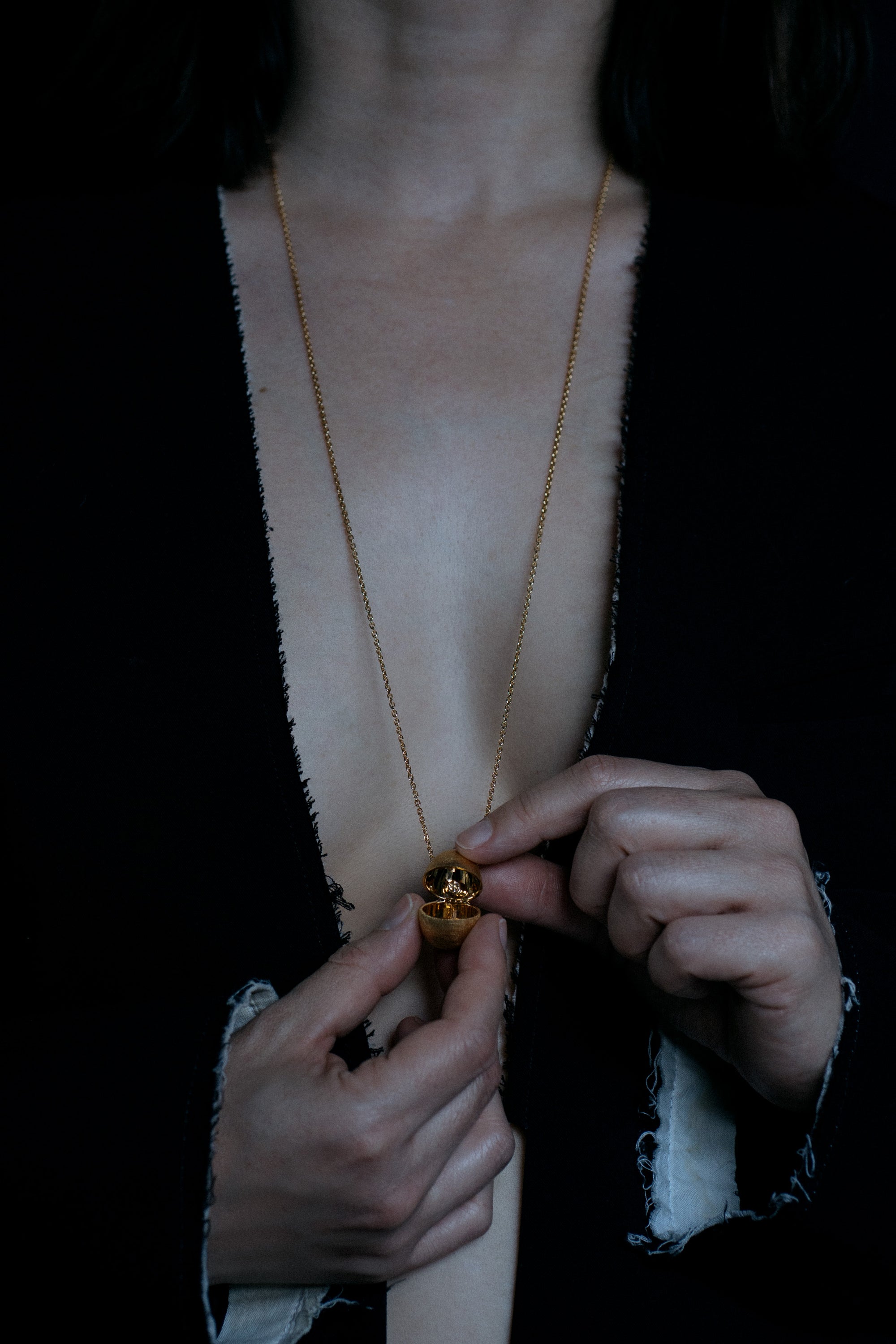 Egg shaped locket vessel necklace in 18k yellow gold on model open