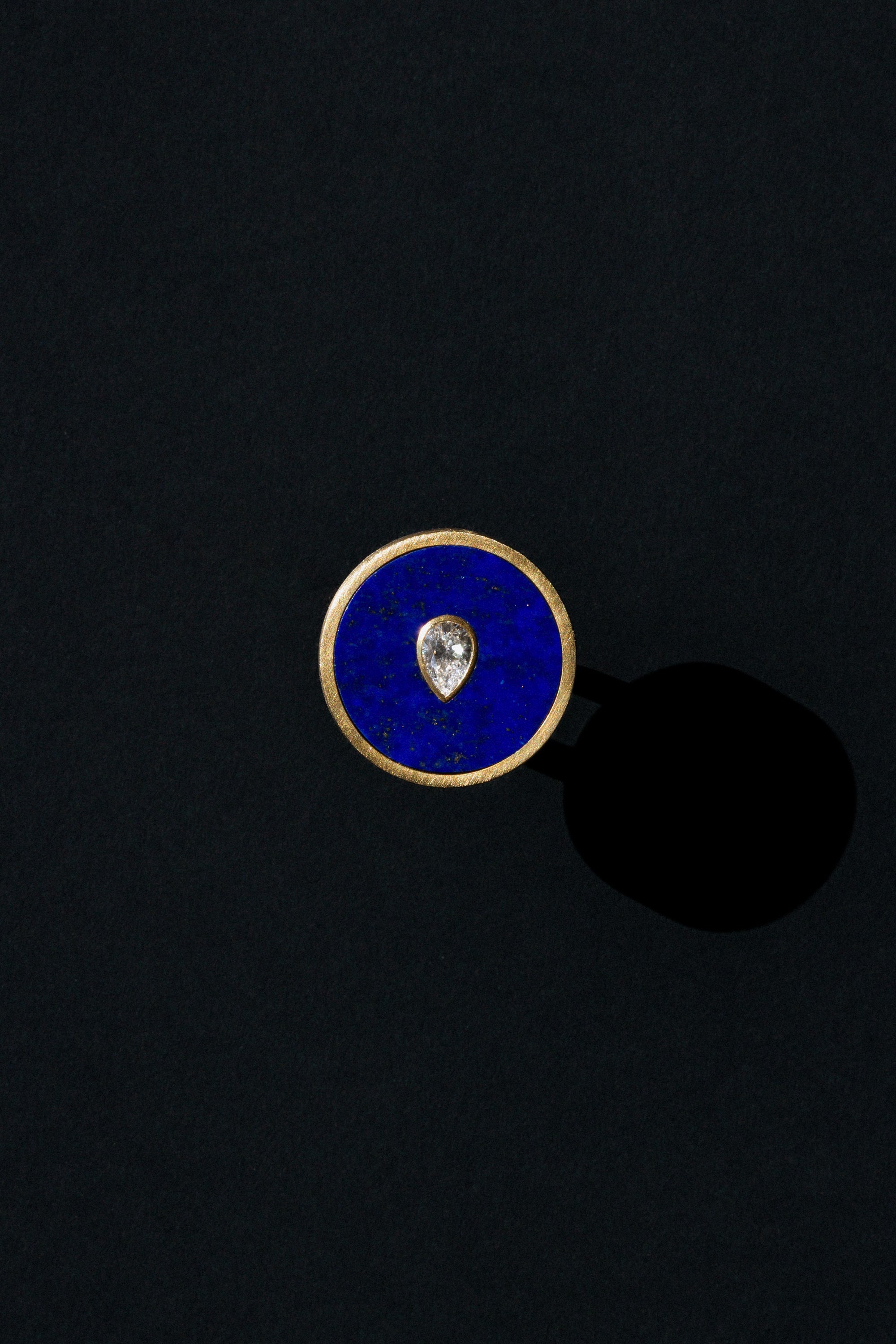Seed ring representing moment of conception 18k yellow gold and pear shaped diamond set in Lapis by Ouvelle