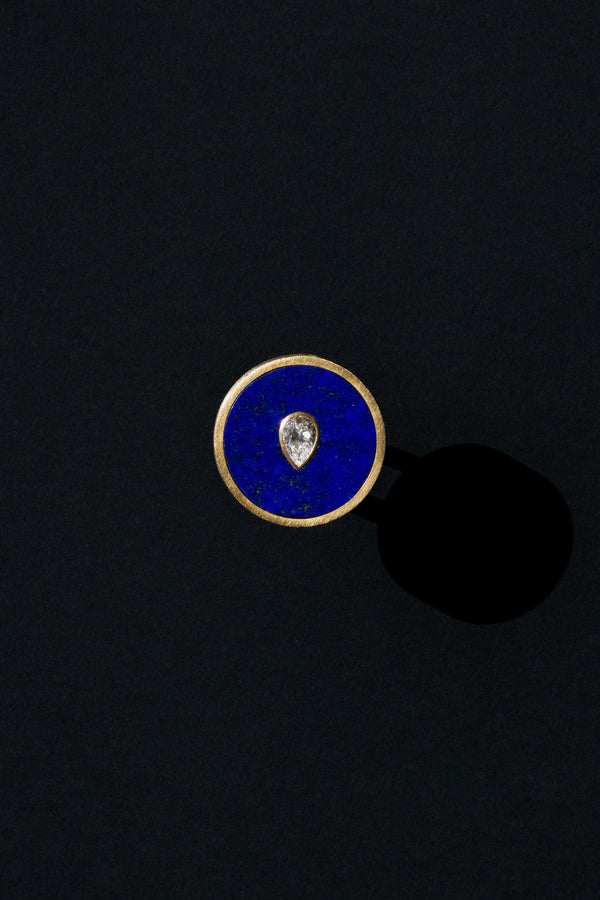 Seed ring representing moment of conception 18k yellow gold and pear shaped diamond set in Lapis by Ouvelle