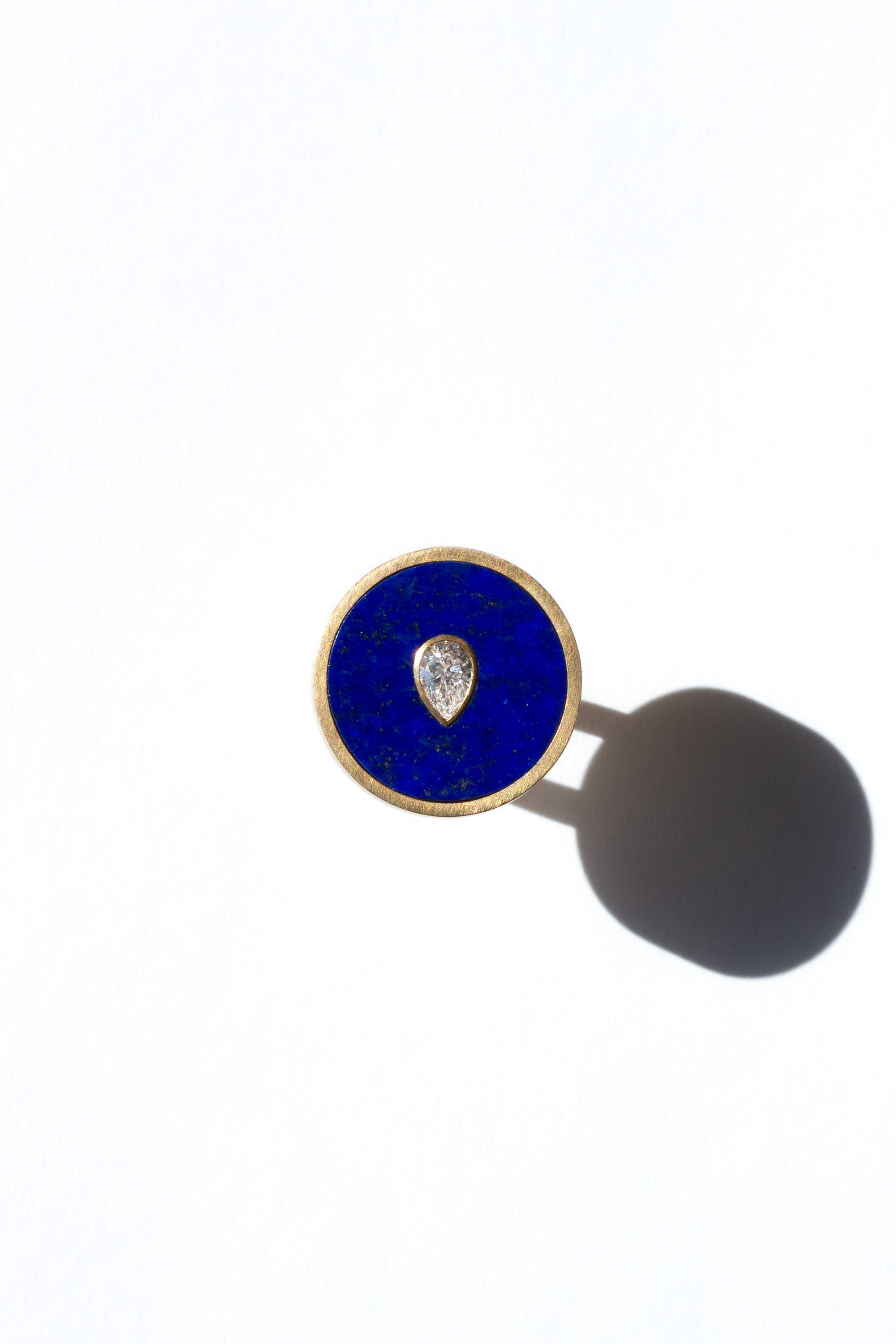 Seed ring representing moment of conception 18k yellow gold and pear shaped diamond set in Lapis inlay by Ouvelle