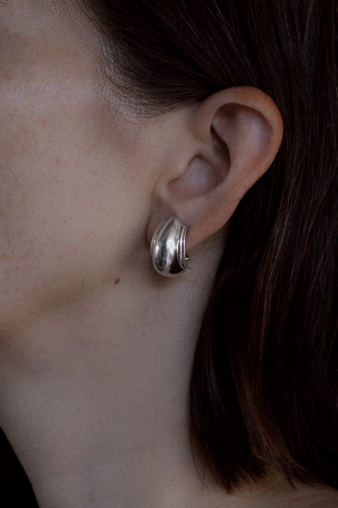 Model wearing Tiffany Paloma Picasso Vendome shell sterling silver earrings