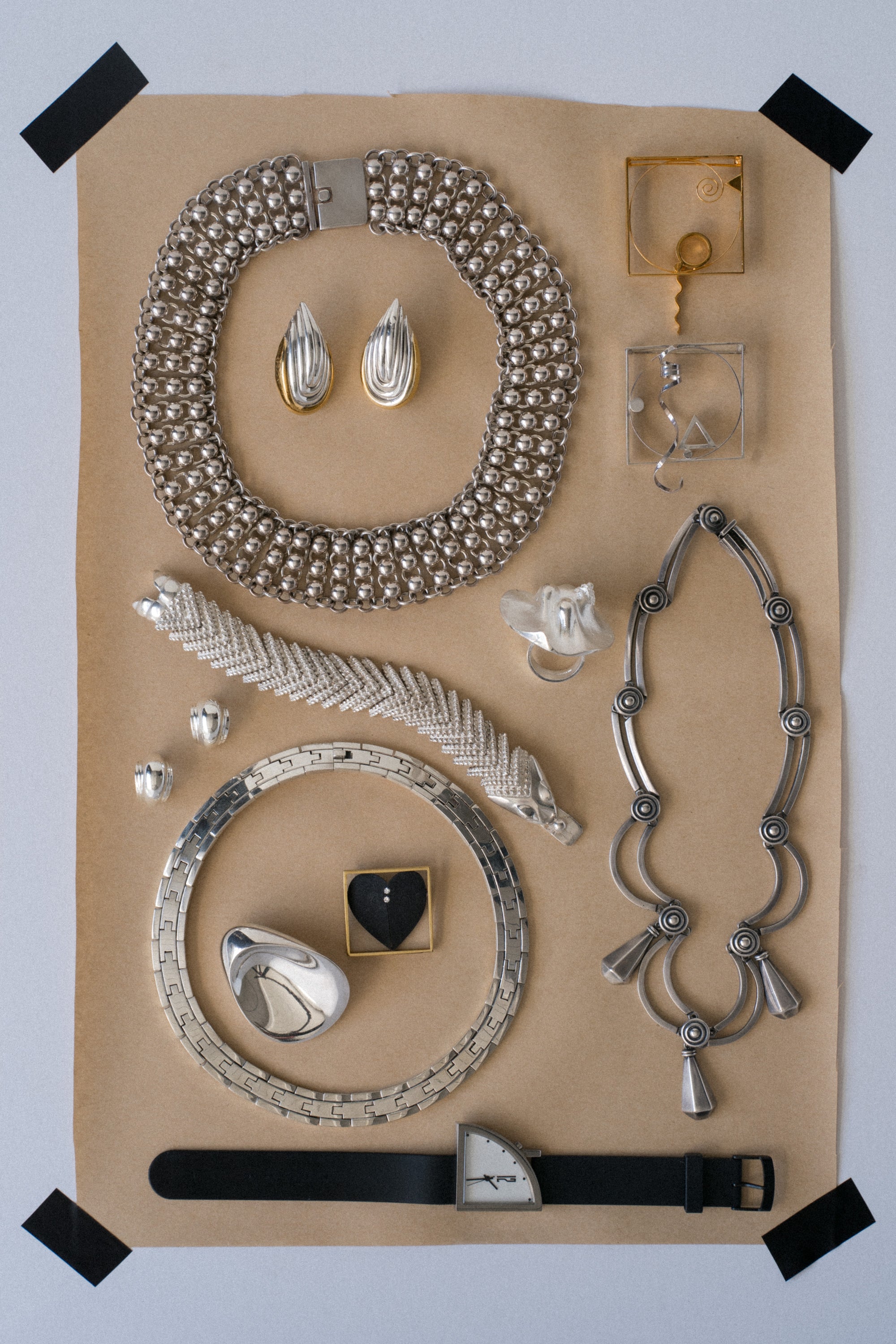 Ouvelle Vintage jewelry selection modern European and taxco on brown paper background
